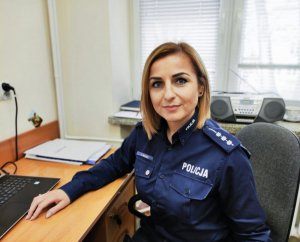 Policjantka w mundurze siedzi przy biurku